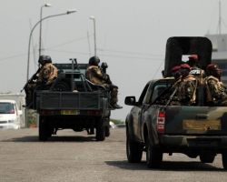 Soldiers of Ivory Coast presidential guard patrol as they arrive at the port of Abidjan