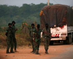 Mutinous soldiers who have taken control of Bouake stand at a checkpoint in Bouake