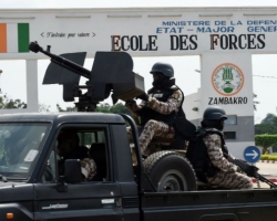 Soldiers of the Ivory Coast presidential guard patrol as they arrive at the port of Abidjan