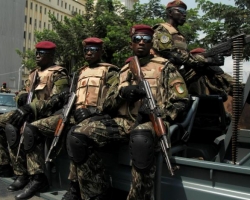 Soldiers of Ivory Coast presidential guard patrol as they arrive at the port of Abidjan