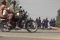 A still image from video thay shows people riding past on a motorbike looking at soldiers standing at a checkpoint in Bouake <span>by REUTERS/via Reuters TV</span>